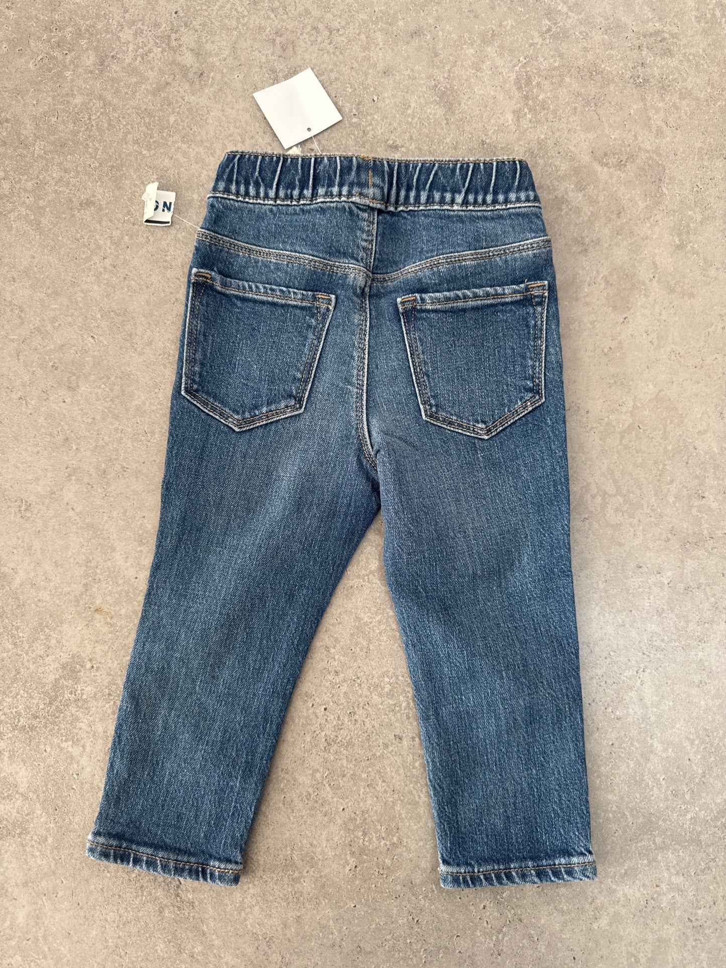 NWT pair of Old Navy Skinny Stretch jeans in a distressed blue wash and 18-24M