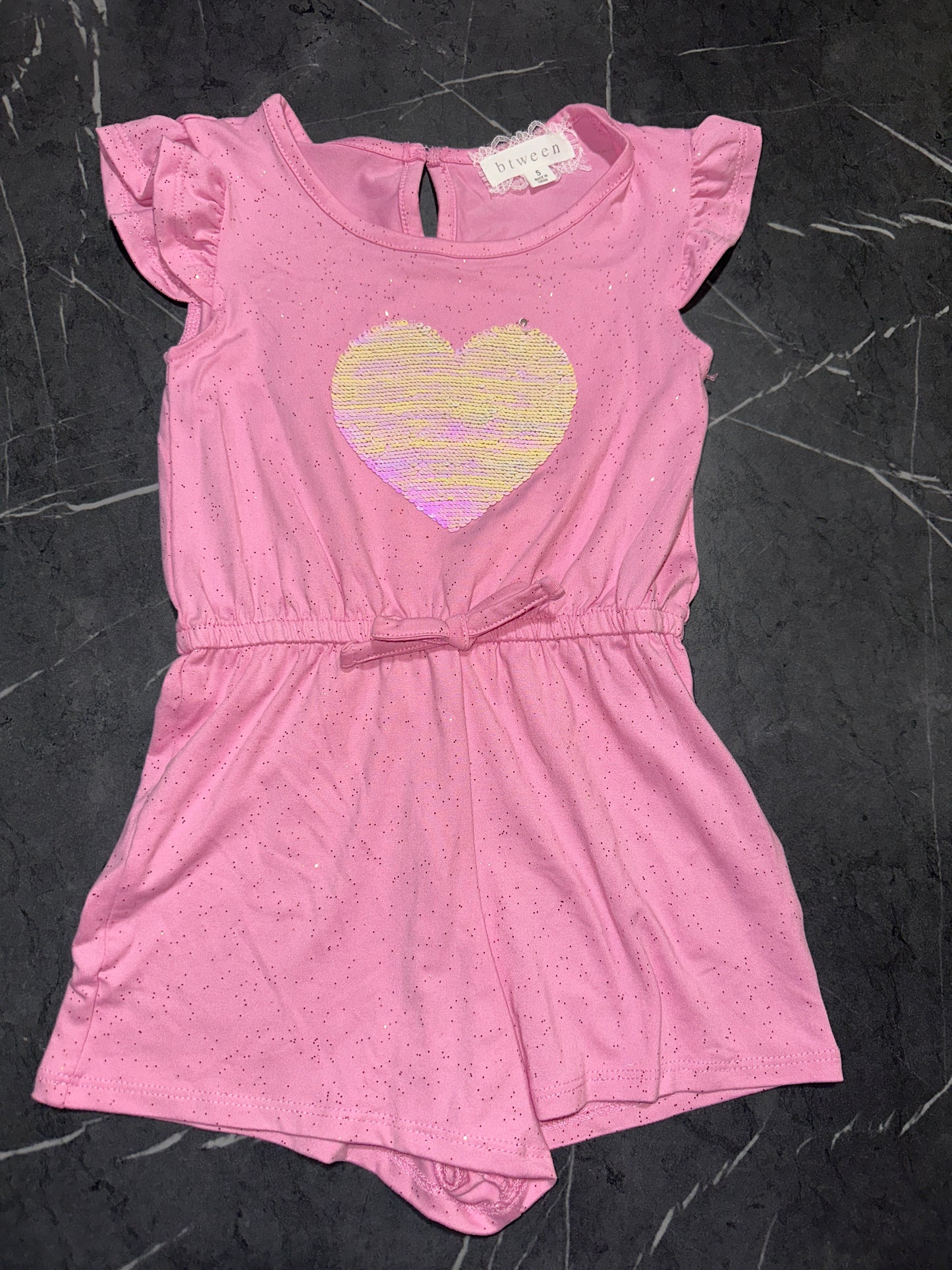 Btween pink children's romper with a sequined heart