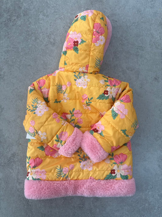 Disney Junior Minnie Mouse reversible puffer jacket with a hood and faux fur trim.