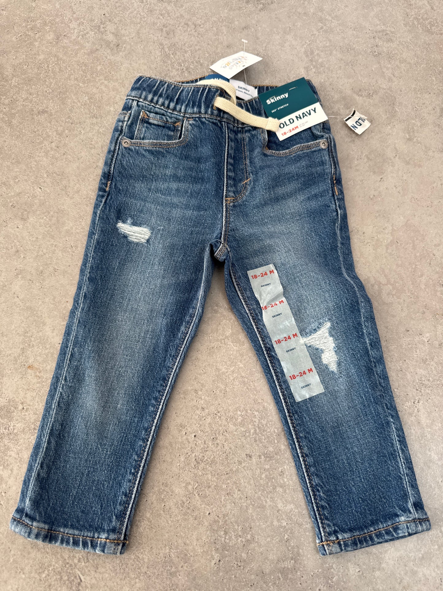 NWT pair of Old Navy Skinny Stretch jeans in a distressed blue wash and 18-24M